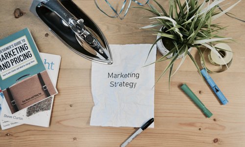 Paper on desk saying Marketing Strategy