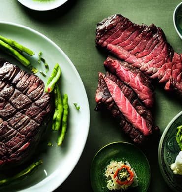 Steak on Plate green background and rare grilled steak on the side